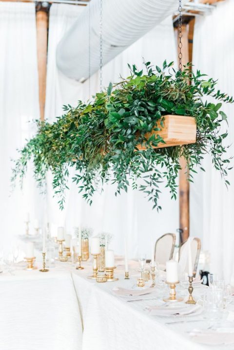 an overhead planter with much lush greenery cascading down to the reception space is a trendy idea