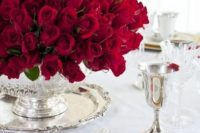 an oversized red rose centerpiece in a silver vase is a gorgeous and refined idea for a Valentine’s Day wedding