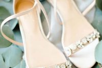 delicate creamy low heel wedding shoes with floral rhinestones and leaves plus straps are amazing for a spring or summer bridal look
