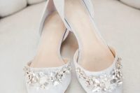 off-white pointed toe flats with large floral embellishments for a romantic feel