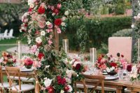 red, pink and blush roses plus greenery for decorating the wedding table and an arch over it is a lovely idea