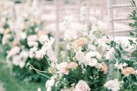 a beautiful and chic spring wedding aisle with lots of greenery, white and blush blooms is a delicate and lovely idea to try