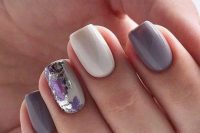 a beautiful spring-style wedding manicure with lilac, white nails and an accent nail done with purple and silver foil detailing
