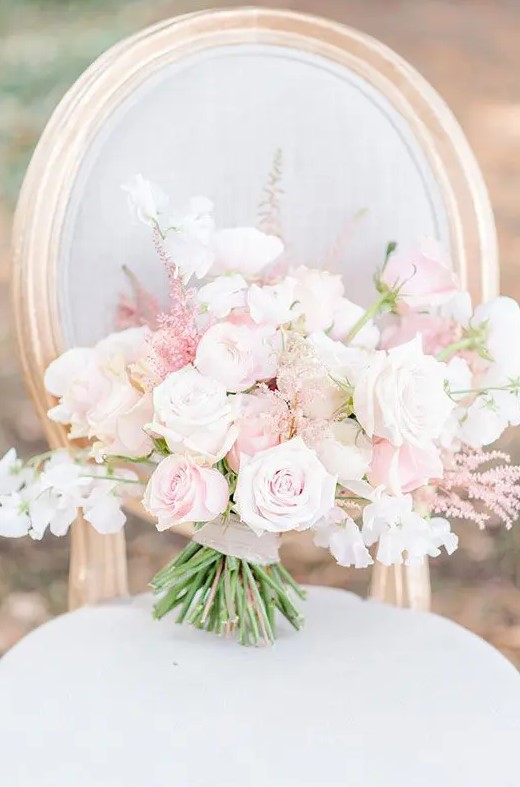 a beautiful wedding bouquet of light pink and white roses, astilbe is a gorgeous candy-colored idea for a spring or summer bride