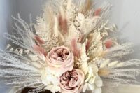 a blush and neutral wedding bouquet of peony roses, white hydrangeas, dried grasses including pampas and lunaria