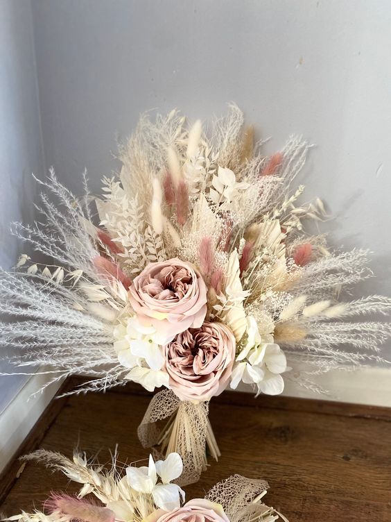 a blush and neutral wedding bouquet of peony roses, white hydrangeas, dried grasses including pampas and lunaria