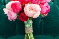 a bold and pretty wedding bouquet of coral, pink and blush peonies and succulents is amazing for summer