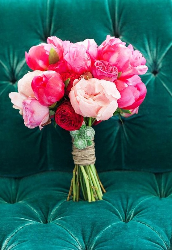 a bold and pretty wedding bouquet of coral, pink and blush peonies and succulents is amazing for summer
