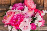 a bold pink wedding bouquet of light and hot pink blooms and greenery is a fantastic idea for a bold wedding