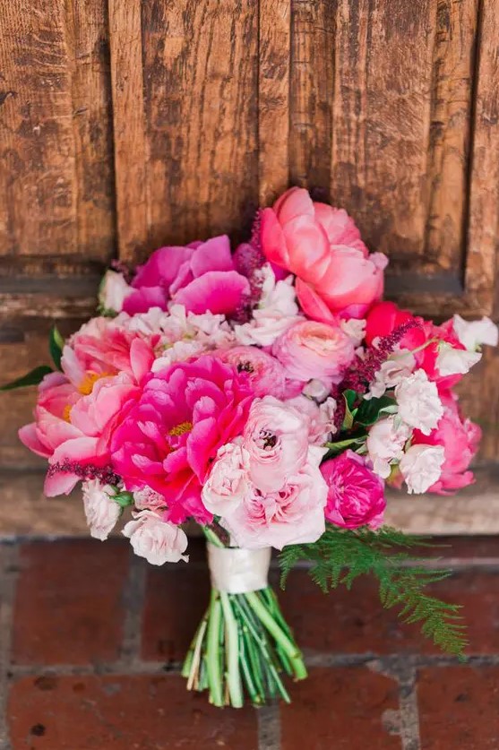 a bold pink wedding bouquet of light and hot pink blooms and greenery is a fantastic idea for a bold wedding