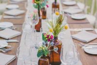 a bright and cute backyard wedding tablescape with neutral linens, bold floral arrangements and candles is a cool idea
