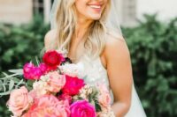 a bright pink wedding bouquet with peonies, roses and hot pink roses plus greenery is amazing