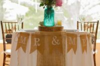 a burlap table runner and a banner are a nice combo for a rustic wedding, they look cozy and are easy to DIY