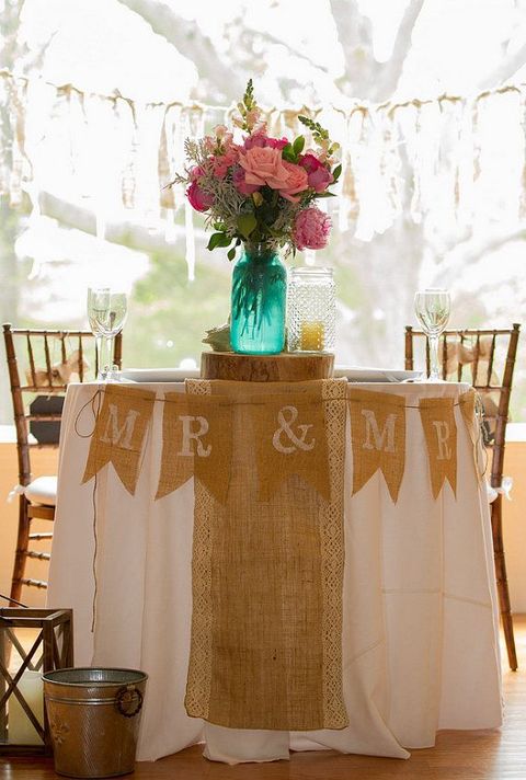 a burlap table runner and a banner are a nice combo for a rustic wedding, they look cozy and are easy to DIY