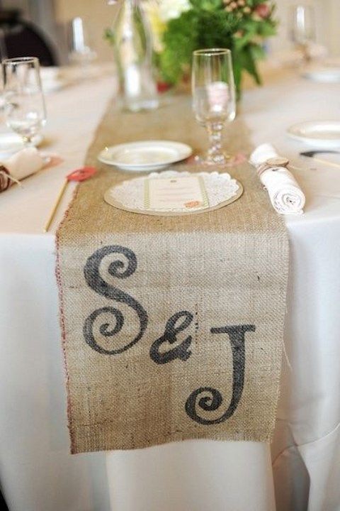 a burlap table runner with monograms is a chic rustic wedding solution to go for