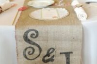 a burlap wedding table runner with monograms always works for rustic and woodland weddings