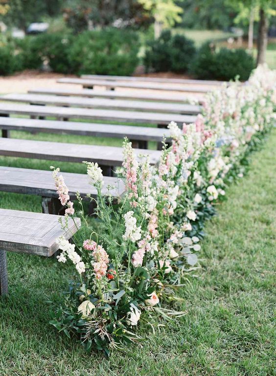 a chic and very simple rustic wedding aisle decorated with greenery, blush and pink blloming branches is amazing