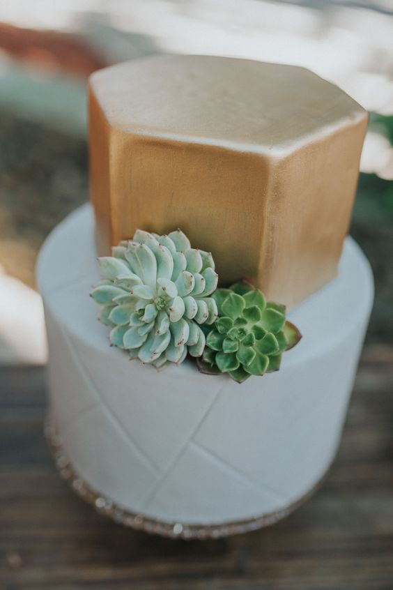 a chic wedding cake with a white striped tier and a gold hexagon one, with succulents is a lovely idea for a geometric wedding
