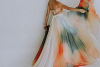 a colorful ombre strapless wedding dress with a flowy skirt with a trian is a bold and chic idea to go for