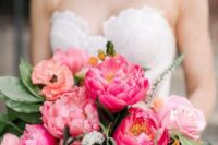 a colorful wedding bouquet of light pink and coral peonies, yellow blooms and greenery is cool for summer