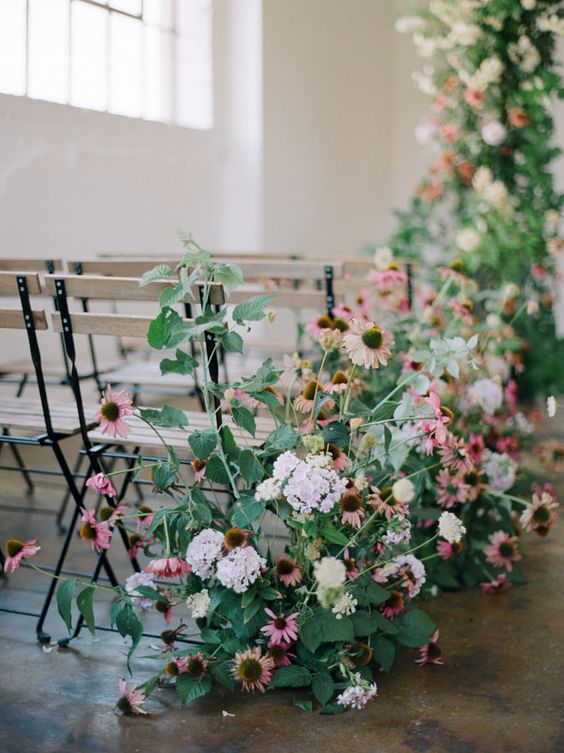 a delicate and chic spring wedding aisle with greenery, lilac, pink blooms feels like a real spring garden