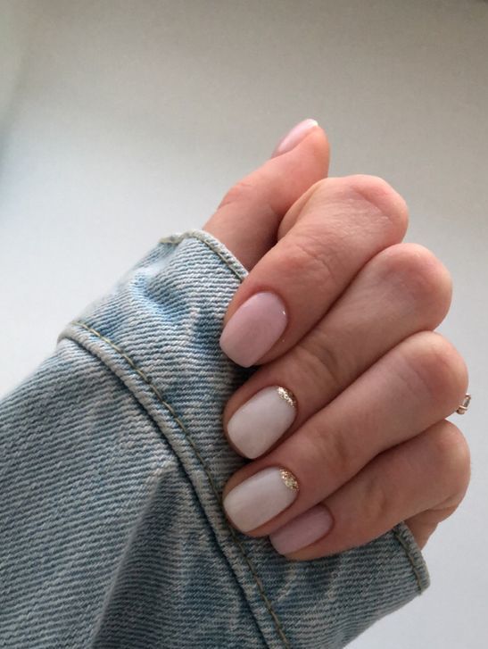 a delicate and pretty wedding manicure with blush and white nails and a touch of gold glitter at the bottom of the nail