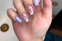 a delicate pastel spring manicure with pink and lilac nails and brushstroke touches, black lines and silver ones