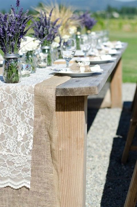 a double wedding table runner of burlap and lace is a cool idea to DIY and it will give a proper rustic feel to the table