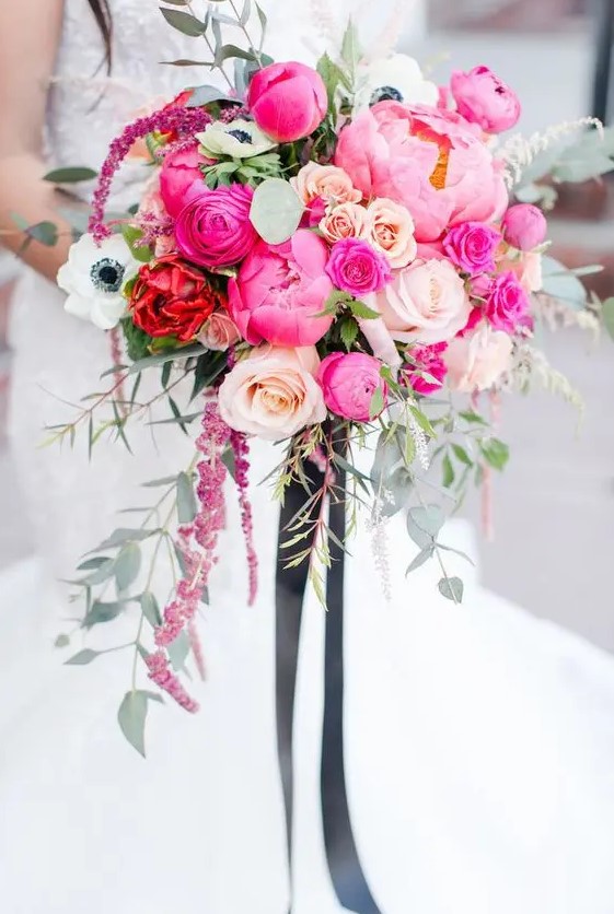 a fantastic wedding bouquet of hot pink peonies, blush roses, white anemones, astilbe and lots of textural greenery plus black ribbons
