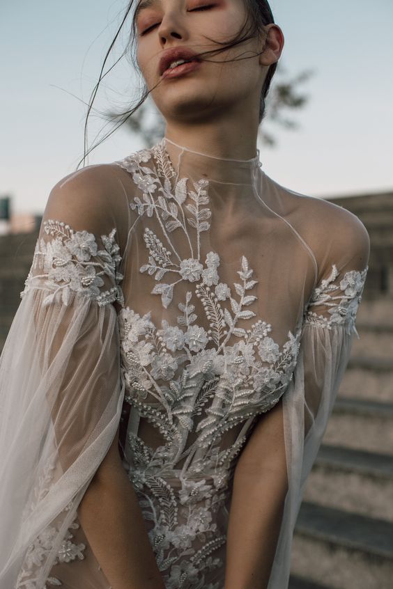 a gorgeous boho floral wedding dress with lace applique and beading, an illusion neckline, cut sleeves is wow
