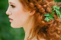 a gorgeous boho messy braided low updo with some fresh greenery tucked in is a great idea for a boho bride