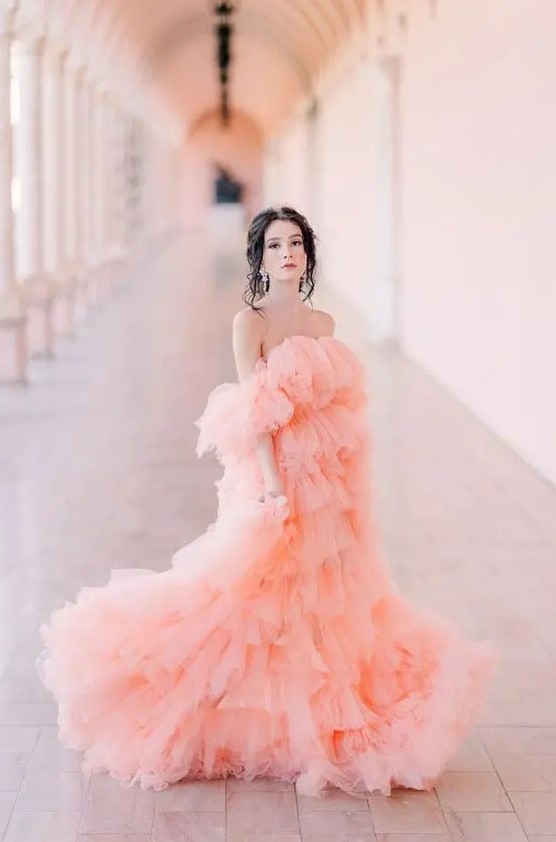 a gorgeous pink layered tulle off the shoulder wedding dress with a train plus statement earrings for a super girlish look