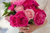 a gorgeous wedding bouquet of pink roses and hot pink peony roses is a stylish idea for a glam bride