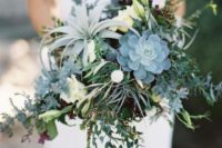 a greenery cascading wedding bouquet with succulents, air plants and foliage plus some white roses for a cooler look