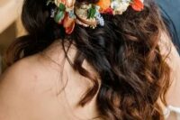 a half updo on long hair, with braids and waves down, with super bright blooms and greenery for a bold fall wedding