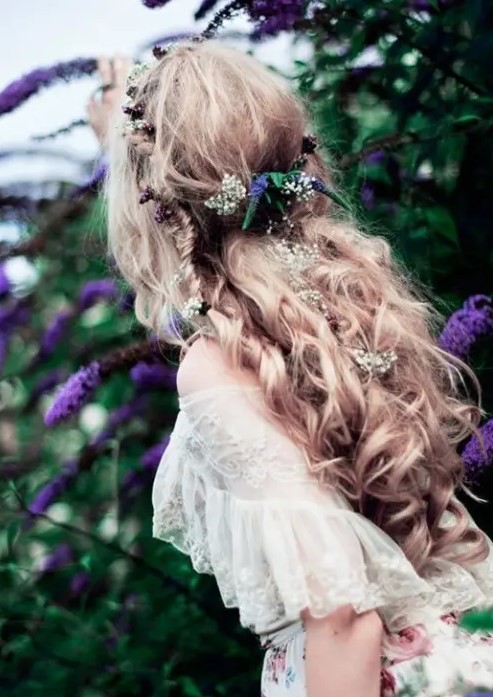 a half updo with waves, twists and braids, with greenery and blooms is a great solution for a boho bride, a spring or a summer one