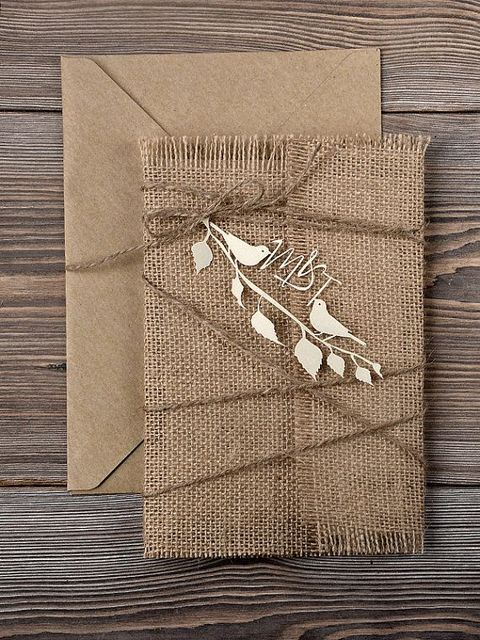 a kraft paper and burlap invitation suite with twine and a cutout plywood piece with calligraphy is a lovely idea for a rustic wedding