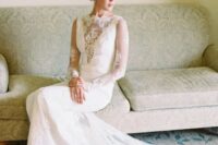 a long sleeve lace wedding dress with an illusion plunging neckline and a long train