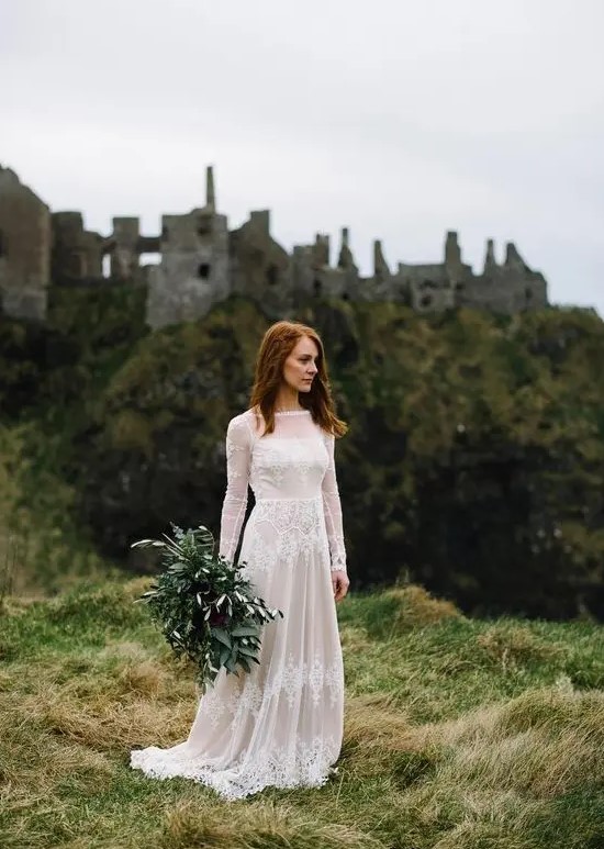 a lovely A-line lace wedding dress with an illusion neckline, long sleeves and a train for a castle elopement