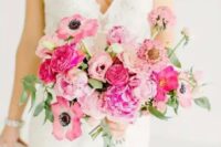 a lovely blush and hot pink wedding bouquet with greenery and long green ribbon hanging down is ideal for a Valentine wedding