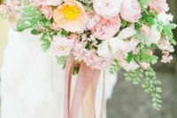 a lush light pink wedding bouquet with lots of greenery, much texture and pink ribbons is a fantastic solution for a spring wedding