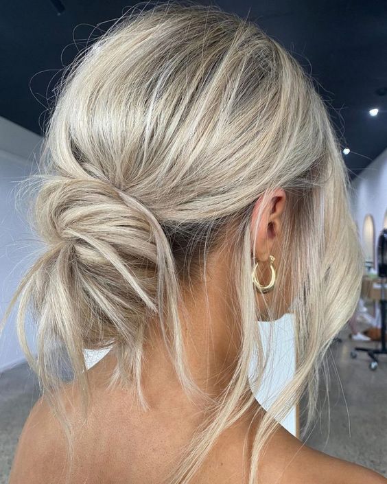 a messy low bun with a volume on top and some locks down is a perfect solution for a casual or boho wedding