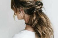 a messy low ponytail with a twsited part and some locks down is idea for hair with lowlights, a comfy modern hairstyle