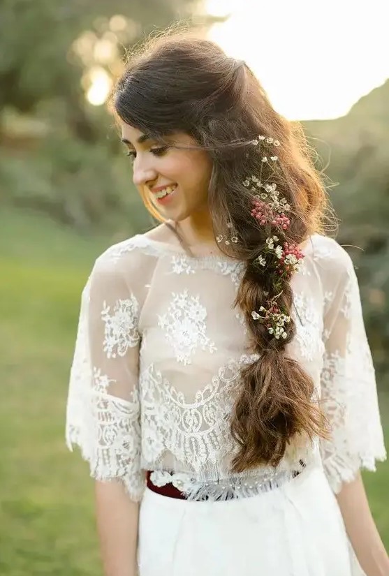 a messy textural twisted braid with some little wildflowers tucked in for a cool and turly boho look