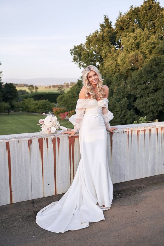 a modern romantic off the shoulder plain wedding dress with puff tulle sleeves and a train is a beautiful solution