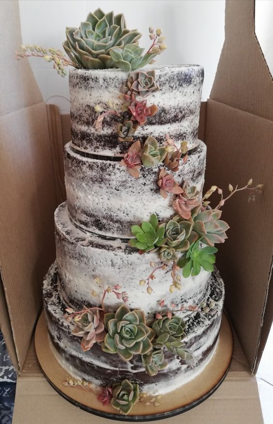 a multi-tier chocolate naked wedding cake with lots of succulents and blooms is a stylish idea for a rustic wedding