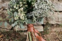 a pale greenery wedding bouquet of various kinds of foliage and textural branches is a chic idea