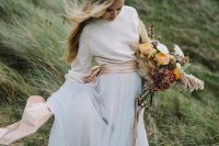 a pearled sweater, a wide blush sash and a layered tulle maxi skirt for a casual and boho bride