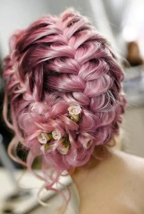 a pink braided wedding updo with some fresh garden roses and waves down for a pciture-perfect look