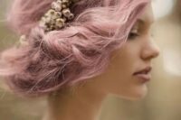 a pink twisted wedding side updo with a bump and a floral crown for an airy and romantic spring bridal look
